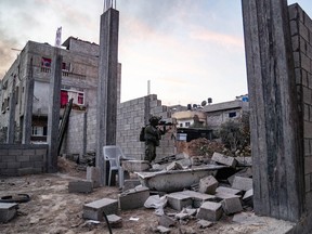 This handout picture released by the Israeli army on December 12, 2023 shows an Israeli soldier manning a position in a building under construction in the Gaza Strip.