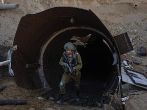 Israeli soldiers exit a tunnel that the military says Hamas militants used to attack the Erez crossing in the northern Gaza Strip, Friday, Dec. 15, 2023.