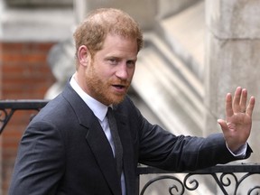 Britain's Prince Harry waves to the media as he arrives at the Royal Courts of Justice in London, on March 30, 2023.