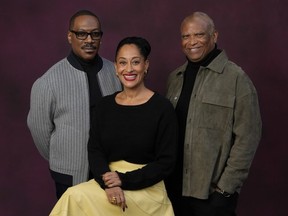 Eddie Murphy, left, and Tracee Ellis Ross, center, cast members in "Candy Cane Lane," and the film's director Reginald Hudlin pose together at the Four Seasons Hotel, Wednesday, Nov. 29, 2023, in Los Angeles.
