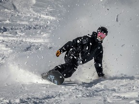 Snowboarder Alex Carpentier enjoys the excellent conditions in the back bowls at the Lake Louise Ski Resort in Banff National Park on Friday, Dec. 15, 2023.
