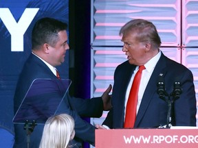 Republican Party of Florida chairman Christian Ziegler, left, greets former president Donald Trump at the RPOF Freedom Summit in Kissimmee, Fla., Nov. 4, 2023.