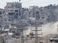 An Israeli tank drives inside the Palestinian enclave of Gaza amid continuing battles between Israel and the militant group Hamas.