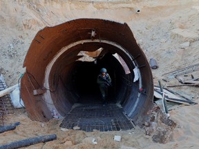 In this picture taken during a media tour organized by the Israeli military on December 15, 2023, an Israeli soldier exits a tunnel that Hamas reportedly used to attack Israel through the Erez border crossing on October 7.