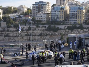 Israeli police and volunteers from the Zaka rescue service work at the shooting attack in Jerusalem, Thursday, Nov. 30, 2023.