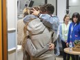 This handout photo provided by GPO on Friday, Dec. 1, 2023, shows Israeli released hostage Mia Shem reuniting with her family at Sheba Medical Center in Tel Hashomer, Ramat Gan, Israel. Mia Shem was released the night of Thursday, Nov. 30, 2023.