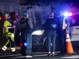 Neighborhood residents speak to Austin Police officers in Austin, Texas late Tuesday, Dec. 5, 2023. Texas authorities say a daylong series of attacks in Austin has left four people dead and at least three injured, and a man believed to be connected to them and the deaths of two people near San Antonio was taken into custody.