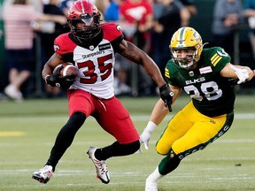 The Edmonton Elks' Adam Konar (38) battles the Calgary Stampeders' Ka'Deem Carey (35) during first half CFL action at Commonwealth Stadium in Edmonton, Saturday Sept. 10, 2022. Photo By David Bloom