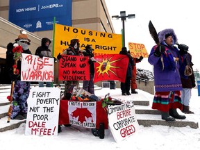 Demonstrators protest the recent removal of homeless camps outside the Edmonton Police Service headquarters on Wednesday, Jan. 10, 2024.