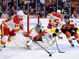 Philadelphia Flyers goaltender Carter Hart and defenceman Cam York defend against Calgary Flames forward Elias Lindholm at Wells Fargo Center in Philadelphia on Saturday, Jan. 6, 2024.