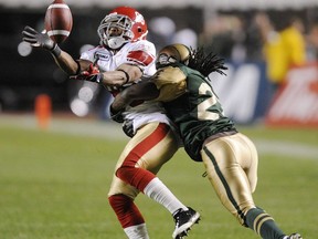 Calgary's Jackie Chambers, left, gets hit by Edmonton's Kelly Malveaux during the second half of CFL action at Edmonton's Commonwealth Stadium on Friday, September 11, 2009. Malveaux, a defensive back who played 10 seasons in the CFL and was a two-time East Division all-star, has died at 47.