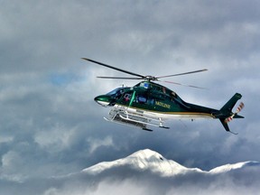 File photo: A Northern Escape Heli Skiing copter flying over the peaks of the Skeena Mountains in 2014.