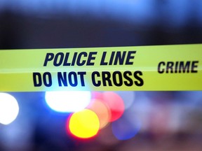 Crime scene tape is illuminated by police lights in Calgary in this file illustration.