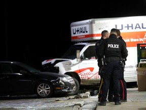 The Edmonton Police Service and RCMP work at the scene of a crash along 50 Street near 22 Avenue SW, in Edmonton on Saturday, Feb. 24, 2024.