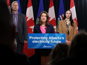 Affordability and Utilities Minister Nathan Neudorf, left, Premier Danielle Smith, and Chestermere-Strathmore UCP MLA Chantelle de Jonge announce the province's renewable energy development strategy, during a news conference at the Alberta legislature in Edmonton on Wednesday, Feb. 28, 2024.