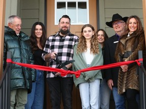 Members of the Contrada family join dignitaries on the front step of their new house during the handover event for the 2023 Calgary Stampede Lotteries Rotary Dream Home in Calgary on Wednesday, February 28, 2024.