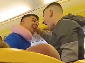 Two men argue during an Edinburgh-to-Canary Island Ryanair flight on Monday, Feb. 19, 2024.