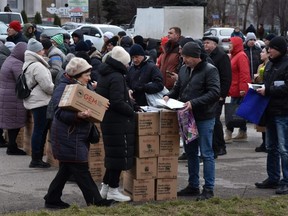 Internally displaced civilians receive humanitarian aid distributed in Zaporizhzhia amid the Russian invasion of Ukraine, Tuesday, Feb. 6, 2024.