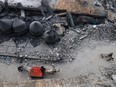 A donkey-pulled car passes in front of the Al-Faruq mosque, levelled by Israeli bombardment in Rafah in the southern Gaza Strip on a foggy day on February 25, 2024.