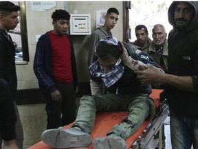 Palestinians wounded in the Israeli bombardment of the Gaza Strip are brought to a hospital in Deir al Balah, Gaza Strip, on Saturday, Feb. 17, 2024.
