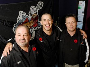 Calgary Roughneck Kaleb Toth, centre, welcomes new head coach Troy Cordingley, right, and assistant coach Terry Sanderson to the team on Nov. 9, 2007.