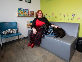 Zebra Child and Youth Advocacy Centre chief executive officer Emmy Stuebing with Captain, the facility dog, on Feb. 14, 2023.
