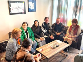 Elder Jackie Bromley (bottom) leads a group prayer alongside Mayor Jyoti Gondek (left) and members of the Aboriginal Friendship Centre of Calgary on Monday at the new warming centre.