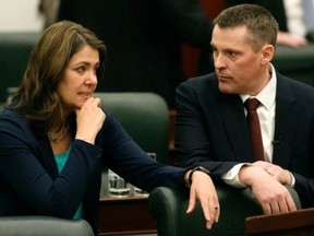 Premier Danielle Smith and Finance Minister Nate Horner chat as they arrive in the Alberta legislature chamber to deliver the 2024 provincial budget in Edmonton on Thursday, Feb. 29.