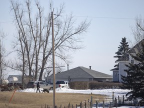 RCMP officers block off a farmhouse northeast of Neudorf, Saskatchewan on Tuesday, March 26, 2024, a day after RCMP announced an investigation into the suspicious deaths of four people found in a rural residence in the area was underway.