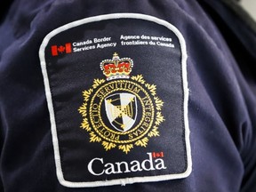 A Canada Border Services Agency patch is seen on an officer in Calgary on Aug. 1, 2019.