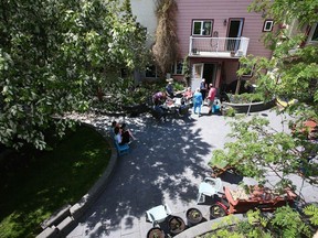 One of the courtyards covered with mature trees is viewed from a resident's balcony at Prairie Sky co-housing in northeast Calgary on Saturday, May 29, 2021. A pair of city councillors is looking for ways to preserve Calgary's tree canopy on private land.