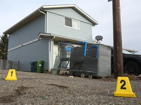 Evidence markers dot the scene as Calgary police investigate a fatal shooting in Radisson Heights in southeast Calgary on Friday, April 1, 2022.