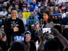 Alberta Premier Danielle Smith speaks to the crowd during Pierre Poilievre's (left) anti carbon tax rally, in Edmonton Wednesday March 27, 2024.