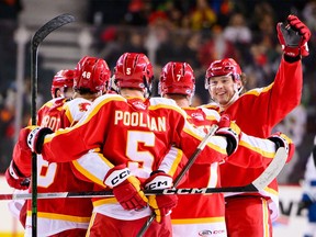 Flames pivot prospect Cole Schwindt, far right, and the Calgary Wranglers have clinched a spot in the 2024 Calder Cup playoffs.