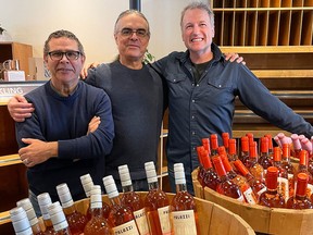 Jonathon Mahonne, from left, Tim Hendrickson and co-owner and general manager Rob Smith were restocking the shelves at the former J. Webb Wine Merchant store at Glenmore Landing on Wednesday, March 20. The store, now known as The Wine Shop, officially reopened on Friday, March 22, 2024.