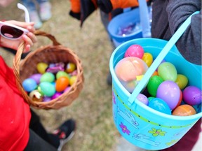 Kids gather with their finds during a neighbourhood Easter egg hunt