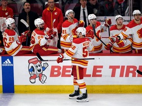 Calgary Flames defenceman MacKenzie Weegar celebrates with teammates after scoring a goal against the Chicago Blackhawks at United Center on Tuesday, March 26, 2024.