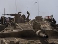 Israeli soldiers drive a tank on the border with Gaza Strip, in southern Israel, Tuesday, March 19, 2024. The army is battling Palestinian militants across Gaza in the war ignited by Hamas' Oct. 7 attack into Israel.