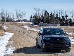 A RCMP vehicle secures the driveway of a home north east of Neudorf, Saskatchewan on Tuesday, March 26, 2024. Black unmarked RCMP vehicles could be seen blocking roads leading to a Saskatchewan farm property as officers continued to investigate the suspicious deaths of four people.