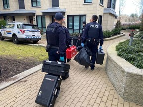 Homicide investigators arrive at a residential property on Shortcut Road, on the edge of the University of British Columbia campus, in Vancouver on Thursday, March 14, 2024.