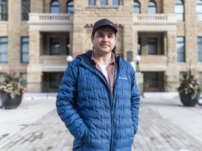 Calgarian and mayoral recall petition organizer Landon Johnston stands in front of city hall on Saturday, February 10, 2024.