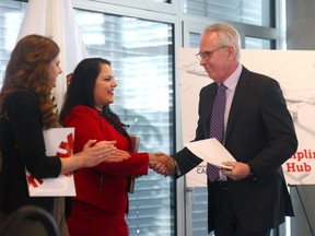 Rajan Sawhney, Minister of Advanced Education and Ed McCauley, president of the University of Calgary, shake hands as Sawhney announced Budget 2024 will invest $55 million toward a new Multidisciplinary Science Hub at the University of Calgary in Calgary on Friday, March 8, 2024.