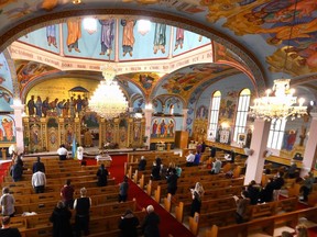 Church goers light candles at the Ukrainian Catholic Church