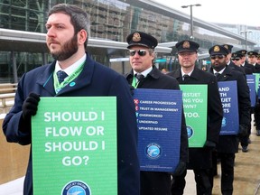 WestJet Encore Airlines pilots picket at the Calgary International Airport on Friday, March 22, 2024.