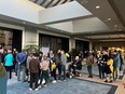 Some of the hundreds of people queueing to take part on public hearings on proposed rezoning at Calgary city hall on Monday, April 22, 2024.