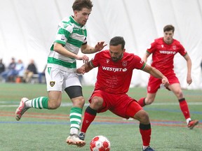 Cavalry FC's Sergio Camargo (right) battles for the ball in the box during an exhibition pre-season soccer match between Cavalry FC and Foothills FC at Calgary West Soccer Centre in Calgary on Saturday, April 6, 2024.