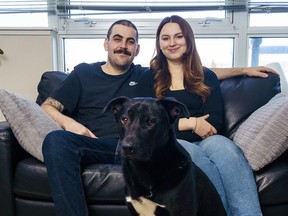 Geoff Boc and Lauren Anderson pose with their dog Pickles in their southwest Calgary apartment on Wednesday, April 10, 2024. Geoff has had two surgeries and gone through stretches of chemotherapy for brain cancer since being diagnosed in October 2022.
