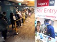 Citizens line up for a variety of subsidized City of Calgary services and cashiers, including a Low Income Transit Pass at the Municipal Building in downtown Calgary on Tuesday, April 30, 2024.