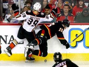 Anaheim Ducks Ben Meyers lowers the boom on Flames forward Dryden Hunt during Tuesday's game.