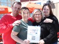(L-R): Jeremy Bockstael, Kelsey Lewis, Kim Streng, and Alana Shah stand in front of the Auburn Bay A&W holding up a flyer for the Martin family GoFundMe page on Tuesday, April 23, 2024.
